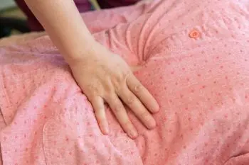 施術者が手のひらで背中にやさしく圧をかけている様子。